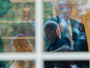 News photographers wait for U.S. President Donald Trump to walk out of the Oval Office to speak with reporters at the White House in Washington, D.C., U.S., April 13, 2026. REUTERS/Jonathan Ernst