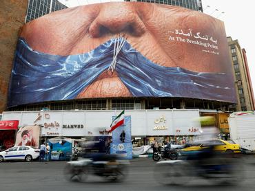 FILE PHOTO: People drive past an anti-U.S. billboard depicting U.S. President Donald Trump and the Strait of Hormuz, in Tehran, Iran, May 17, 2026. Majid Asgaripour/WANA (West Asia News Agency) via REUTERS ATTENTION EDITORS - THIS PICTURE WAS PROVIDED BY A THIRD PARTY/File Photo