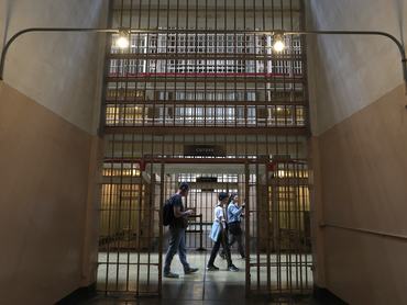 SAN FRANCISCO, CALIFORNIA - JULY 02: Visitors tour a cellblock at Alcatraz Island on July 02, 2025 in San Francisco, California. U.S. President Donald Trump renewed his plans to reopen the tourist attraction Alcatraz prison as a working federal penitentiary. In a Truth Social post on Tuesday, President Trump said that conceptual work to renovate the prison had begun six months ago, and several prison development firms have been involved in preliminary planning.   Justin Sullivan/Getty Images/AFP (Photo by JUSTIN SULLIVAN / GETTY IMAGES NORTH AMERICA / Getty Images via AFP)
