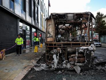 Remains of a burnt bus stand on the Newtownards Road in the aftermath of anti-immigrant protests following a knife attack on June 8, which left a man seriously injured and prompted police to declare a critical incident, Belfast, Northern Ireland, June 10, 2026. REUTERS/Isabel Infantes