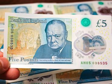 CHINA - 2025/09/29: In this photo illustration, a £5 banknote from the Bank of England is seen displaying Winston Churchill and iconic British landmarks like Big Ben. (Photo Illustration by Sheldon Cooper/SOPA Images/LightRocket via Getty Images)
