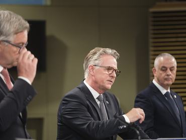 BRUSSELS, BELGIUM - JUNE 26: EU Commissioner for Internal Affairs and Migration Magnus Brunner (L) the acting Executive Director of Europol Jurgen Ebner (C) and the chief of Cyprus Police Themistos Arnaoutis (R) talk to media in the Berlaymont, the EU Commission headquarter on June 26, 2026 in Brussels, Belgium. Today, the European Commission and Europol have released a new analysis of over 700 criminal networks operating across the EU, involving more than 400,000 members from 118 countries, with 85% using legal business structures to exploit systemic vulnerabilities for activities like drug trafficking, cybercrime, and money laundering. To address this evolving threat, the Commission has proposed strengthening Europol's mandate with enhanced tools and legal frameworks for cross-border investigation.  (Photo by Thierry Monasse/Getty Images)