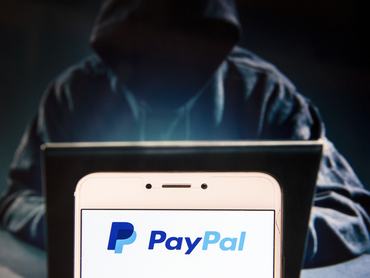 HONG KONG, CHINA - 2018/11/27: In this photo illustration, the American online payment platform Paypal logo is seen displayed on an Android mobile device with a figure of hacker in the background. (Photo Illustration by Miguel Candela / SOPA Images/SOPA Images/LightRocket via Getty Images)