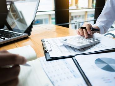 business audits using a calculator financial data investment fund at a workplace, wealth concept