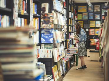 Female student searching for books in the campus library
