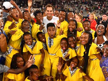 CAPE TOWN, SOUTH AFRICA - FEBRUARY 07: Roger Federer of Switzerland hugs the kids after the Match in Africa between Roger Federer and Rafael Nadal at Cape Town Stadium on February 07, 2020 in Cape Town, South Africa. (Photo by Ashley Vlotman/Gallo Images/Getty Images)