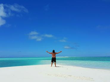 Maldives white sandy beach young man standing on sunny tropical paradise island with aqua blue sky sea ocean 4k