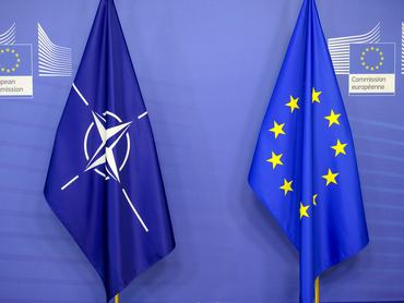 BRUSSELS, BELGIUM - SEPTEMBER 26: North Atlantic Treaty Organization (L) and European Union (R) flags are seen in the Berlaymont building on September 26, 2022 in Brussels, Belgium. While thousands of Russian citizens are fleeing their country to escape the fighting in Ukraine, the Twenty-Seven are torn over the question of their possible reception. (Photo by Thierry Monasse/Getty Images)