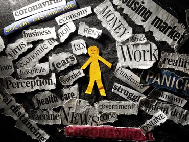 Paper man surrounded by Coronavirus and economy news headlines