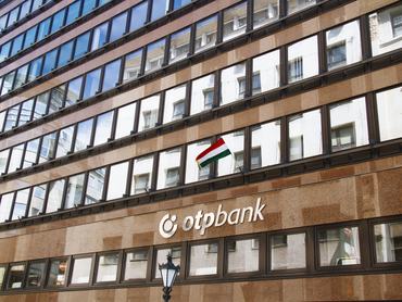 OTP Bank Branch with Flag of Hungary in Deak Ferenc Street and Vorosmarty Square, 5th District of Budapest Downtown, Hungary in April 2021 - OTP Bank Group is one of the largest independent financial service providers in Central and Eastern Europe with full range of banking services for private individuals and corporate clients. The OTP Bank was established in Budapest, Hungary in 1949. Nowadays the bank hosts an international organization called the OTP Bank Group. The several parts of the group work in different areas of business.