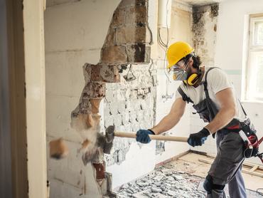 Worker using hammer, home renovation