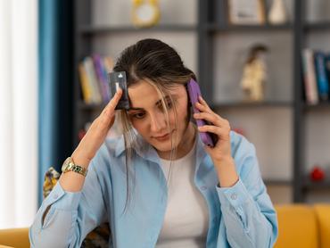Worried woman call bank unable pay by card