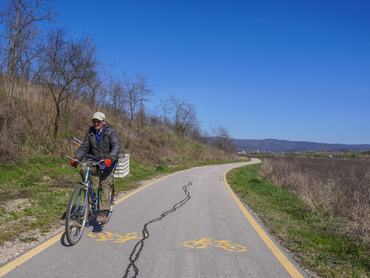 An old man is cycling on the bicycle path in Bogacs, Hungary, on March 26, 2024. (Photo by Michal Fludra/NurPhoto via Getty Images)