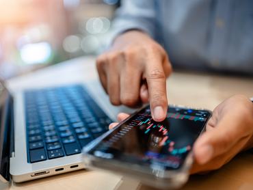 Investors analyze the data stock market index via digital tablet screen to trade the stock chart for planning investments take profit, trade stock exchange market and cryptocurrency data, financial.