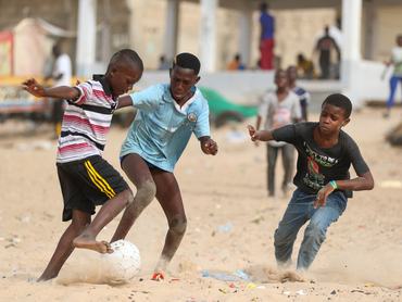 DAKAR, SENEGAL - JUNE 13: Senegalese children who build post out of old automobile tires usually play soccer barefoot or in slippers, in Dakar, Senegal on June 13, 2024. YOFF Beach in Dakar is one of the places where children spend the most time. In their free time from school, children gather on the fine sandy beach on the shores of the Atlantic Ocean and spend their energy playing soccer. The African continent, where approximately 600 million children live, is home to the world's largest out-of-school child population and the largest number of child laborers. On the Day of the African Child, various events are organized around the world every year to draw attention to the victimization of children in Africa and to raise awareness. (Photo by Cem Ozdel/Anadolu via Getty Images)