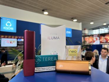 19 September 2024, North Rhine-Westphalia, Dortmund: An Iqos brand tobacco heater (left) from Philip Morris stands next to a Glo brand tobacco heater from British American Tobacco (BAT) on a shelf at the Intertabac trade fair. The corresponding tobacco sticks of the Terea (for Iqos) and Neo (for Glo) brands are also on display. (to dpa: Away from the fag? Cigarette companies promote alternatives) The Intertabac trade fair begins on Thursday in Dortmund, where not only cigarettes, cigars and pipes, but also tobacco heaters and e-cigarettes will be promoted. Photo: Wolf von Dewitz/dpa (Photo by Wolf von Dewitz/picture alliance via Getty Images)