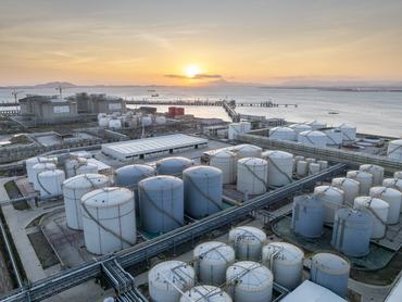 Rows of oil storage tanks at a seaside chemical plant