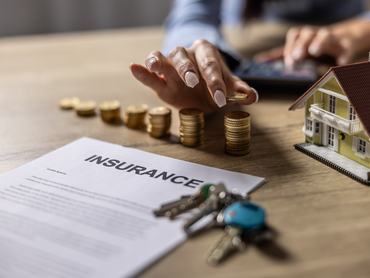 Saving money for real estate investment with pile of coins for financial or insurance concept stock photo
