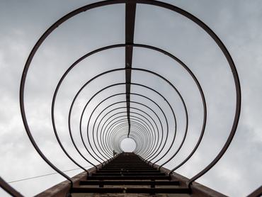Industrial ladder on tall chimney