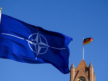 25 September 2025, Schleswig-Holstein, Flensburg: A NATO flag flies in the wind in front of the German national flag. Photo: Frank Molter/dpa (Photo by Frank Molter/picture alliance via Getty Images)