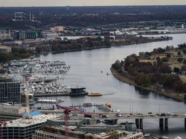 WASHINGTON, DC - NOVEMBER 14: A Potomac Water Taxi floats on the Washington Channel while arriving at the Wharf, on November 14, 2025 in Washington, DC. Across the river is East Potomac Park, and beyond the Wharf is the National War College, a part of the National Defense University at Fort Lesley J. McNair. (Photo by Al Drago/Getty Images)