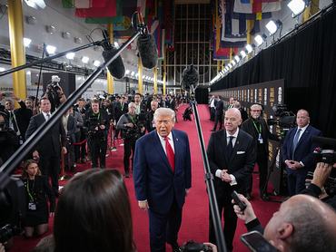 WASHINGTON, DC - DECEMBER 05: U.S. President Donald Trump answers questions from reporters as he arrives on the red carpet with FIFA President Gianni Infantino (R) for the FIFA World Cup 2026 Official Draw at the John F. Kennedy Center for the Performing Arts December 05, 2025 in Washington, DC. The 2026 FIFA World Cup will take place between June 11 and July 19 featuring 48 teams with matches being played in the United States, Mexico and Canada, the first time the international sporting event will be hosted by three nations. (Photo by Andrew Harnik/Getty Images)