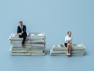 Man and woman figures sitting on unequal stacks of dollar bills. Gender pay gap, income inequality, financial disparity, and salary discrimination concept.