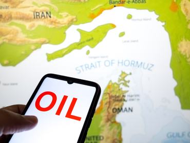 The word OIL appears on a smartphone screen, and a map shows the Strait of Hormuz on a laptop computer screen in this photo illustration taken in Athens, Greece, on March 3, 2026. (Photo by Nikolas Kokovlis/NurPhoto via Getty Images)