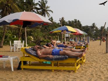 A foreign tourist sunbathes on a Mount Lavinia beach in Colombo, Sri Lanka, on March 9, 2026. US-Israel strikes on Iran spark Gulf retaliation; 10,000 tourists are stranded in Sri Lanka, which grants emergency visa extensions. (Photo by Akila Jayawardena/NurPhoto via Getty Images)
