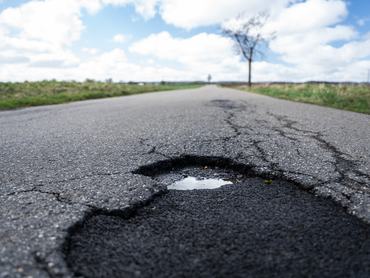 SYMBOL - 12 March 2026, Baden-Württemberg, Rottweil: Cracks and potholes can be seen on a road near Dietingen (Rottweil district). Photo: Silas Stein/dpa (Photo by Silas Stein/picture alliance via Getty Images)