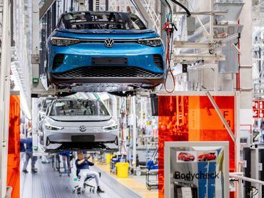 PRODUCTION - 24 February 2026, Lower Saxony, Emden: Employees work on an assembly line at the Volkswagen plant on ID.4 (front) and ID.7 vehicles. The Volkswagen plant in Emden has been fully geared towards the production of electric cars since 2024. Photo: Hauke-Christian Dittrich/dpa (Photo by Hauke-Christian Dittrich/picture alliance via Getty Images)