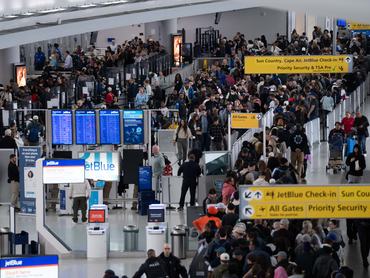 NEW YORK, NEW YORK - MARCH 22: People wait in long TSA security lines at John F. Kennedy International Airport on March 22, 2026 in New York, New York. The travel disruptions continue as hundreds of TSA agents quit or work without pay during a partial government shutdown. U.S. President Donald Trump said ICE agents will be deployed to U.S. airports on Monday, with border czar Tom Homan in charge of the effort. (Photo by Adam Gray/Getty Images)