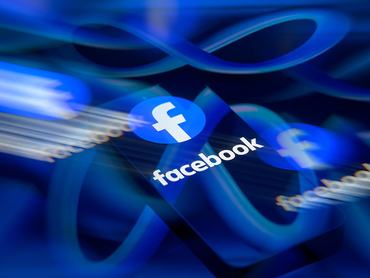The Facebook logo is displayed on a smartphone screen in this photo illustration in Brussels, Belgium, on March 29, 2026. Meta Platforms expands its AI services while facing regulatory pressure in Europe over data use, competition rules, and access to rival AI tools. (Photo by Jonathan Raa/NurPhoto via Getty Images)
