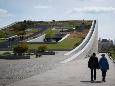 An elderly couple walks along a sidewalk beside the Museum of Ethnography (Neprajzi Muzeum) in Budapest, Hungary, on April 10, 2026. (Photo by Mateusz Wlodarczyk/NurPhoto via Getty Images)