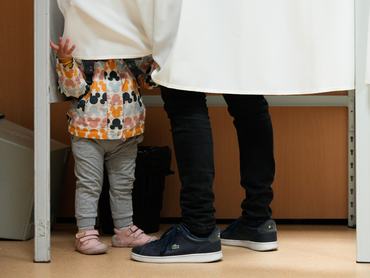 A small child stands next to a voter in a booth in the 12th district in Budapest, Hungary on 12 April, 2026. (Photo by Jaap Arriens/NurPhoto via Getty Images)