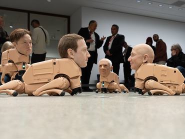 BERLIN, GERMANY - MAY 7:  Autonomous robotic dogs fitted with hyper-realistic silicone heads modelled after  US entrepreneur Mark Zuckerberg (C-front) US entrepreneur Jeff Bezos (R), Spanish artist Pablo Picasso (C-back), US entrepreneur Elon Musk (L)  and other well-known people, walk around as part of the interactive art installation Regular Animals by US artist Beeple (born Mike Winkelmann), at Neue Nationalgalerie on May 7, 2026 in Berlin, Germany. The work marks a new phase in Beeple's practice, expanding his engagement with AI and digital art into an immersive physicaldigital environment, and represents his first institutional exhibition in Germany.  (Photo by Christian Ender/Getty Images)