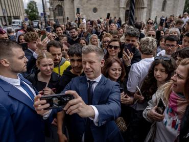 BUDAPEST, HUNGARY - MAY 16: Péter Magyar, Prime Minister of Hungary, takes selfies with his supporters after he gave the press a tour as the Orban-era prime minister's office building, the Carmelite Monastery, is opened to the public on May 16, 2026 in Budapest, Hungary. Former Prime Minister Viktor Orban moved into the renovated Carmelite Monastery in Budapest's Buda Castle in January 2019, after a lengthy and expensive renovation project. Now, as the new Prime Minister Peter Magyar seeks to distance himself from the era of his predecessor, he has relocated the prime minister's office and is opening the Carmelite Monastery to the public for an extended period so that anyone can visit it free of charge. (Photo by Janos Kummer/Getty Images)