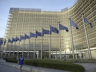 BRUSSELS, BELGIUM - MAY 24: EU flags are seen in front of the Berlaymont, the EU Commission headquarter on May 24, 2026 in Brussels, Belgium. The Berlaymont building serves as the headquarters of the European Commission, housing the offices of the Commission President, various Directorates-General, and extensive meeting facilities where EU policies are developed and coordinated. Beyond its administrative function, its iconic cross-shaped design and public esplanade make it a symbolic landmark and a key meeting point for staff, visitors, and exhibitions showcasing the European Union's work. (Photo by Thierry Monasse/Getty Images)