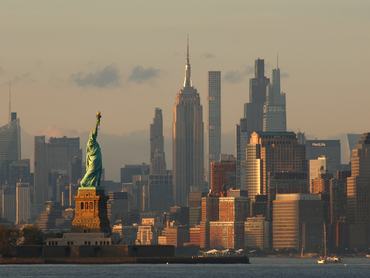 BAYONNE, NJ - MAY 25: The sun sets on the Statue of Liberty and the Empire State Building in New York City on May 25, 2026, as seen from Bayonne, New Jersey. (Photo by Gary Hershorn/Getty Images)
