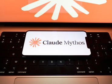 The Claude Mythos logo is displayed on the screen of a smartphone placed on a laptop keyboard, with the company's branding illustration on the screen, in Creteil, France, on June 10, 2026. Anthropic announces the release of two new Mythos-class artificial intelligence models for cybersecurity and biomedical research, targeting both consumers and businesses. (Photo by Samuel Boivin/NurPhoto via Getty Images)