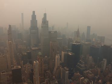 NEW YORK, NY - JULY 16: Smoke from wildfires in Canada shrouds midtown Manhattan, seen from the 86th-floor observation deck of the Empire State Building on July 16, 2026, in New York City. (Photo by Gary Hershorn/Getty Images)