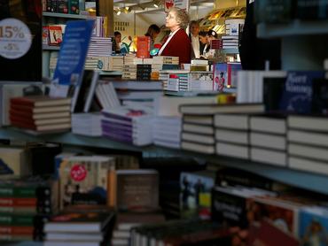 BUDAPEST, HUNGARY - APRIL 23: A visitor goes over the books during the 22th Budapest International Book Festival at Millenaris Culture Center in Budapest, Hungary on April 23, 2015. (Photo by Arpad Kurucz/Anadolu Agency/Getty Images)