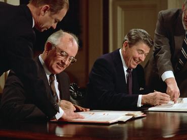 US President Ronald Reagan and Soviet leader Mikhail Gorbachev signing the arms control agreement banning the use of intermediate-range nuclear missiles, the Intermediate Nuclear Forces Reduction Treaty, Washington DC, 8th December 1987.
