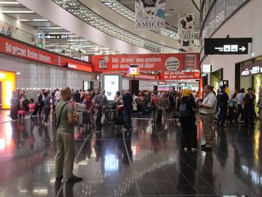 VIENNA, AUSTRIA - AUGUST 28: Passengers wait at the Vienna International Airport in Schwechat, Vienna, Austria on August 28, 2016 due to a technical fault in airport that causes mass delays. (Photo by Hasan Tosun/Anadolu Agency/Getty Images)