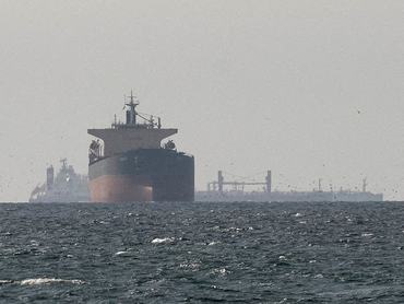 FILE PHOTO: Cargo ships in the Gulf, near the Strait of Hormuz, as seen from northern Ras al-Khaimah, near the border with Oman’s Musandam governance, amid the U.S.-Israeli conflict with Iran, in United Arab Emirates, March 11, 2026. REUTERS/File Photo