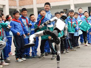 RENHUAI, CHINA - MARCH 31, 2026 - Elementary school students are watching an intelligent robot performance at Renhuai Experimental Primary School in Guizhou Province, China, on March 31, 2026. (Photo credit should read CFOTO/Future Publishing via Getty Images)