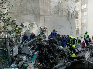 KYIV, UKRAINE - MAY 14: Rescue workers clear the rubble of a destroyed apartment building after a Russian drone and missile attack on May 14, 2026 in Kyiv, Ukraine. Several districts of the city came under attack, with part of a residential building completely destroyed in one of the strikes. 5 people were killed and more than 40 others, including children, were injured. 10 people are considered missing as search and rescue operations continue. (Photo by Andrii Khodkov/Apostrophe/Global Images Ukraine via Getty Images)