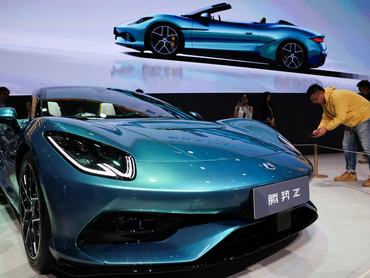 A man films the newly presented Z Convertible EV of BYD's luxury brand Denza at the company’s booth at the Beijing International Automotive Exhibition (Auto China), in Beijing, China, April 24, 2026. REUTERS/Maxim Shemetov