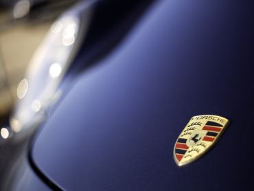 Halifax, Nova Scotia, Canada - December 11, 2011: Porsche Logo on hood of Cayman R. Porsche is a manufacturer of vehicles that includes the popular 911 series of vehicles, the Boxster, The Cayman, the Cayenne, and the Panamera. The Porsche logo is one of the most recognized in the automotive business.