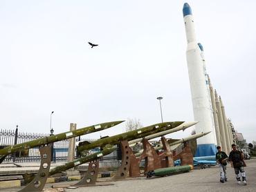People walk near Iranian missiles in a park, amid the U.S.-Israeli conflict with Iran, in Tehran, Iran, March 26, 2026. Majid Asgaripour/WANA (West Asia News Agency) via REUTERS ATTENTION EDITORS - THIS PICTURE WAS PROVIDED BY A THIRD PARTY
